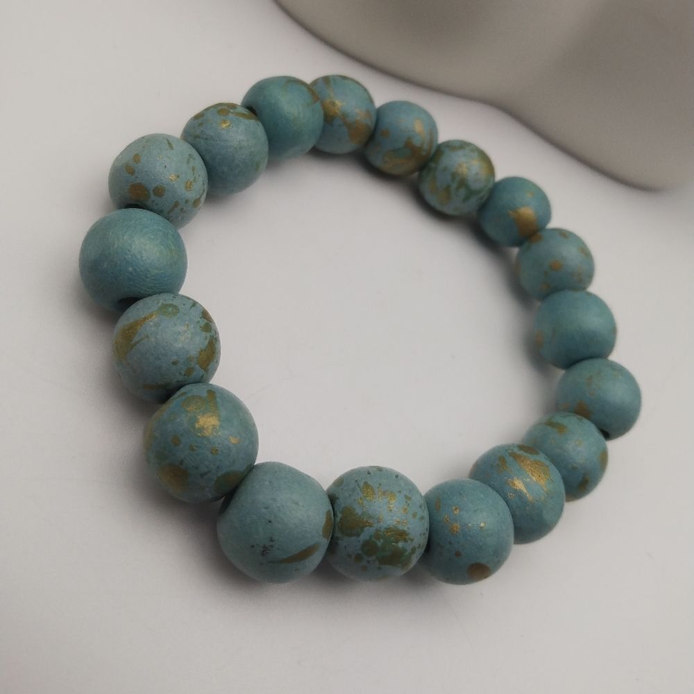 Blue on gold spackled wooden ball bracelet